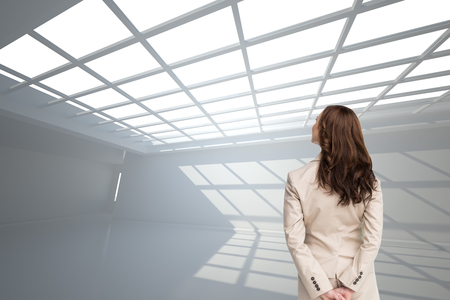 Composite image of rear view of businesswoman looking awayの写真素材