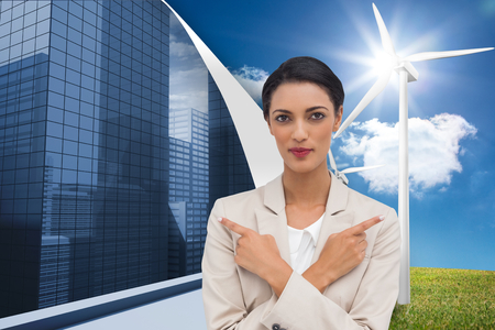 Composite image of charismatic businesswoman with her arms crossed and fingers pointingの写真素材