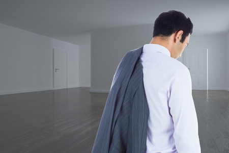 Composite image of unsmiling businessman standingの写真素材