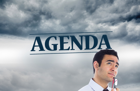 Composite image of thinking businessman holding glassesの写真素材