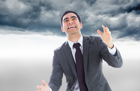 Composite image of stressed businessman catchingの写真素材