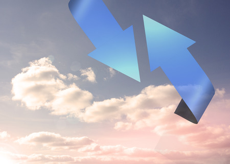 Blue arrows pointing against skyの写真素材