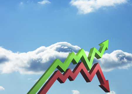 Red and green arrows against blue skyの写真素材