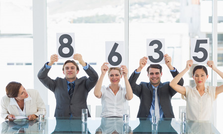 Portrait of a group of panel judges holding score signsの写真素材