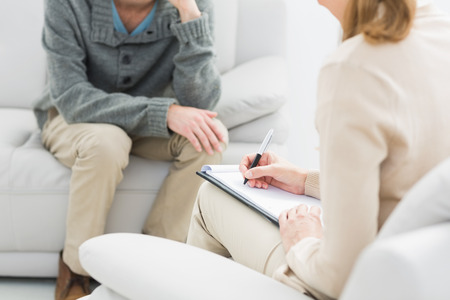 Mid section of man in meeting with a financial adviser at homeの写真素材