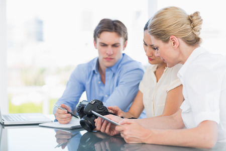 Young businessman and women working together at office deskの写真素材