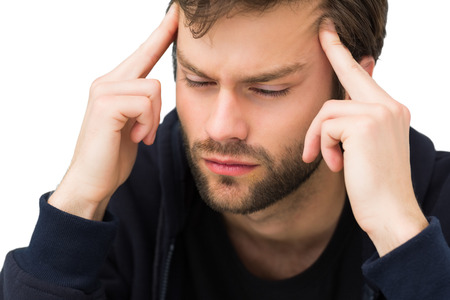 Close-up of a handsome young man with headache over white background