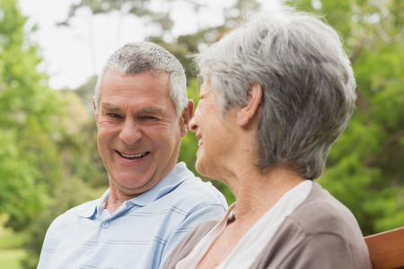 Close-up of a happy senior man and woman looking at each other at the park