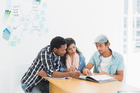 Group of casual artists working at desk in the creative officeの写真素材