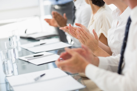 Business people clapping at a meeting in the officeの写真素材