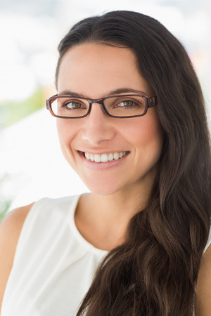 Gorgeous young designer smiling at camera in creative officeの写真素材