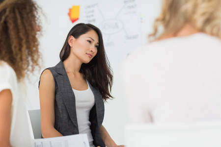 Asian woman listening at a meeting in creative officeの写真素材