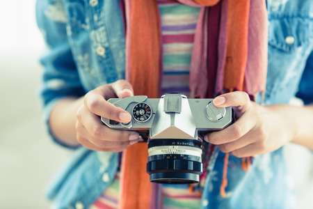 Young woman looking at her camera at home in the living room