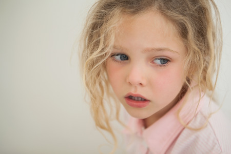 Close-up of a beautiful serious young girl looking away