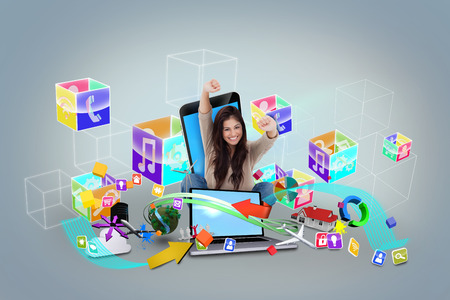 Digital composite of cheering girl using laptop with app iconsの写真素材