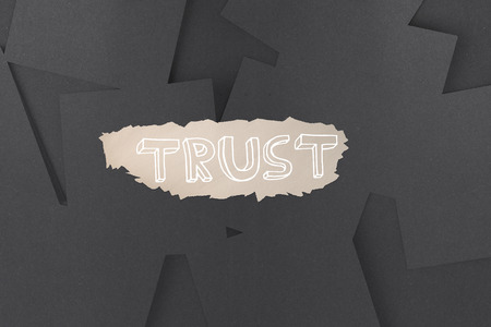 The word trust against digitally generated grey paper strewnの写真素材