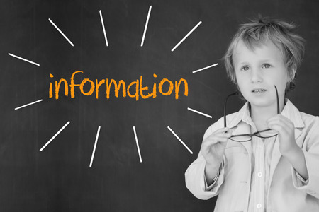 The word information against schoolboy and blackboardの写真素材