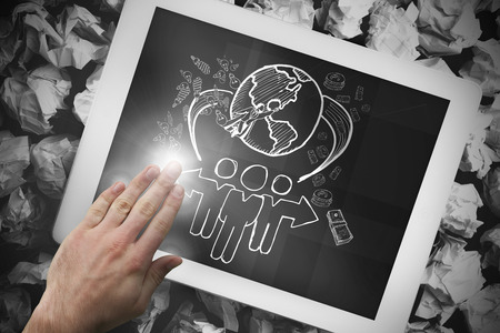 Composite image of hand touching tablet showing global community doodleの写真素材