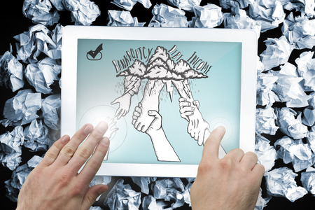 Composite image of hand touching tablet showing bankruptcy and debt doodle with helping handsの写真素材