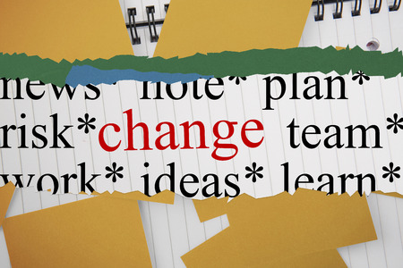 The word change against yellow paper strewn over notepadの写真素材
