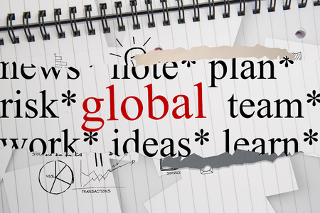 The word global against brainstorm doodles on notepad paperの写真素材