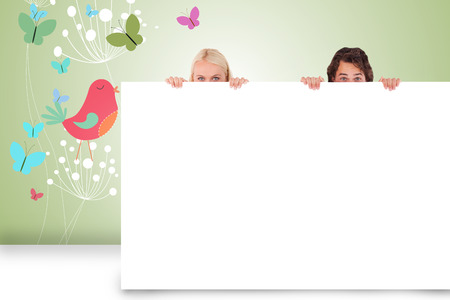 Composite image of attractive couple showing cardの写真素材