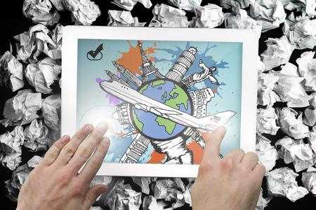 Composite image of hand touching tablet showing global tourism concept on paint splashesの写真素材