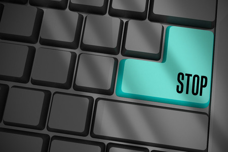 The word stop on black keyboard with blue keyの写真素材