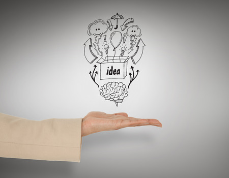 Female hand presenting idea box against grey vignetteの写真素材