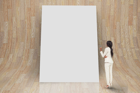 Composite image of thinking businesswoman against white cardの写真素材