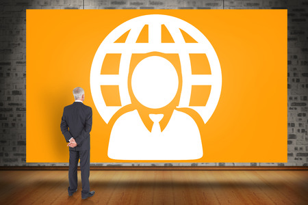 Composite image of rear view of mature businessman posing against orange cardの写真素材