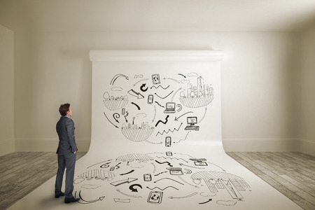 Thinking businessman against large white screen showing doodleの写真素材