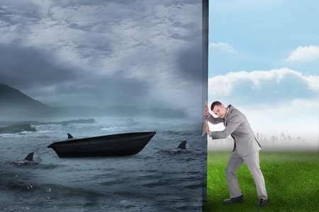 Composite image of businessman pushing away scene of sail boat being circled by sharksの写真素材