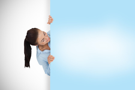 Composite image of businesswoman showing blue cardの写真素材