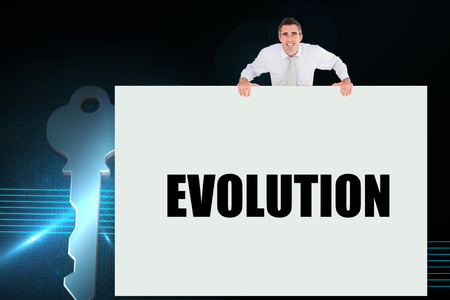 Businessman holding card saying evolution against digital backgroundの写真素材