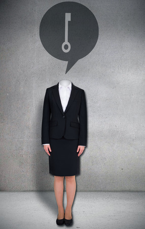 Composite image of headless businesswoman with key in speech bubble in grey roomの写真素材