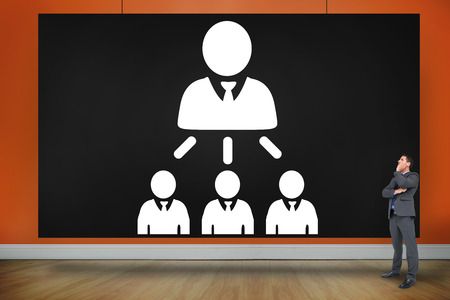 Composite image of thinking businessman against black cardの写真素材