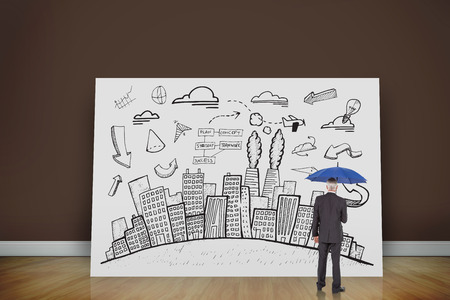 Composite image of businessman holding umbrella against white cardの写真素材