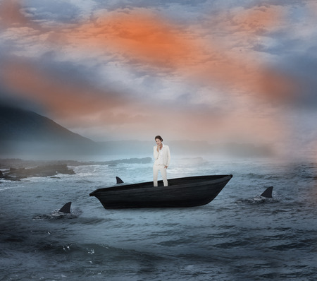 Composite image of thinking businesswoman in a sailboat being circled by sharks