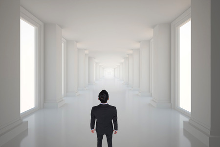 Asian businessman against bright hall with windowsの写真素材