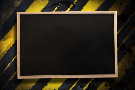 Chalkboard with wooden frame against linear design with paint splashesの写真素材