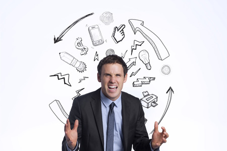 Stressed businessman gesturing against idea brainstormの写真素材