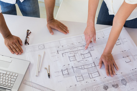 Casual architecture team working together at desk in the office