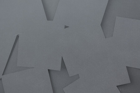 Digitally generated grey paper strewn over grey surfaceの写真素材