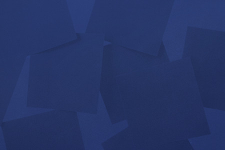 Digitally generated blue paper strewn over blue surfaceの写真素材