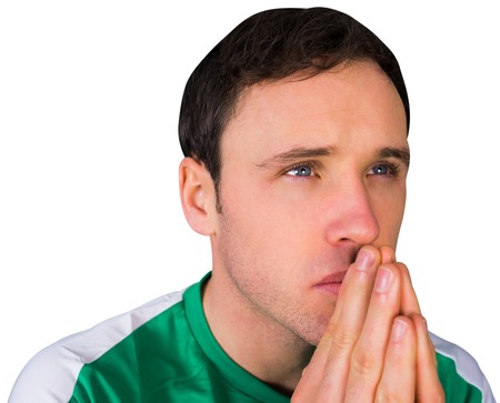 Nervous football fan in green on white backgroundの写真素材