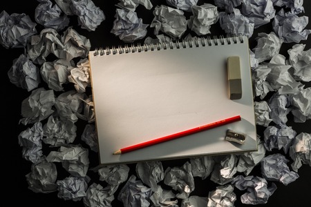 Paper notebook with pencil eraser and parer on dark backgroundの写真素材