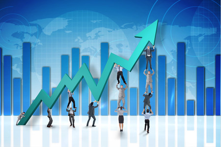 Business team holding up arrow against global business graphic in blueの写真素材