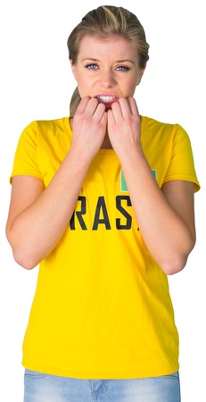 Nervous football fan in brasil tshirt on white backgroundの写真素材