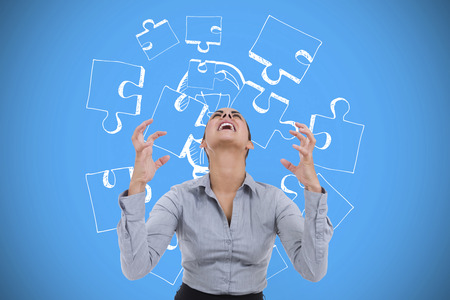 Furious businesswoman gesturing against blue background with vignetteの写真素材
